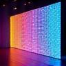 Dynamic LED wall displaying abstract, pulsating electronic art visuals with seamless video mapping effect.