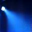 Graphic icon of a moving head spotlight emitting dynamic beams of light.